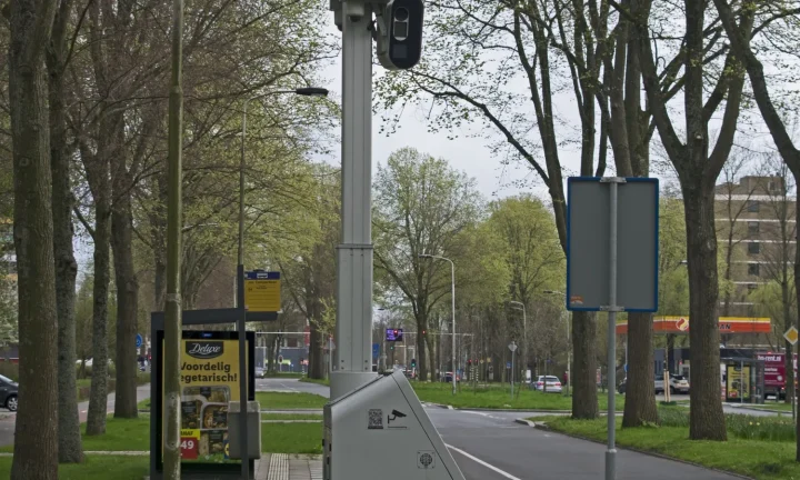 Radar fixe installé le long d’une route urbaine bordée d’arbres