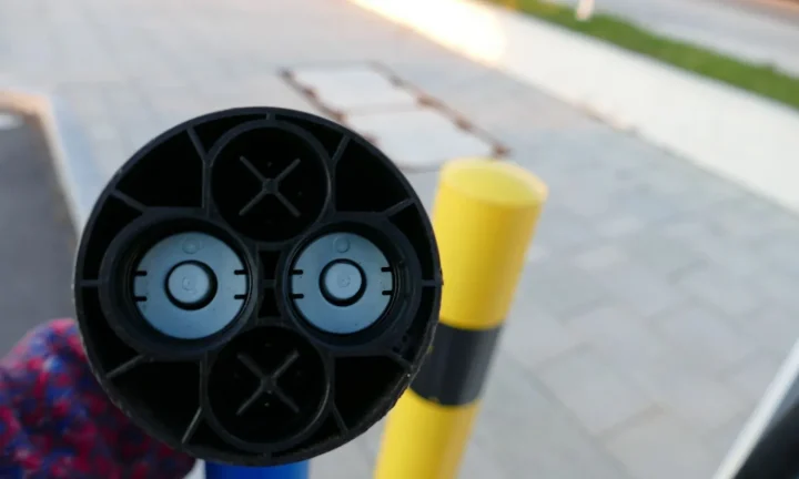 Voiture électrique réelle photographiée près d’une borne de recharge pour « Bornes de recharge intelligentes et subventions : optimisez votre investissement »