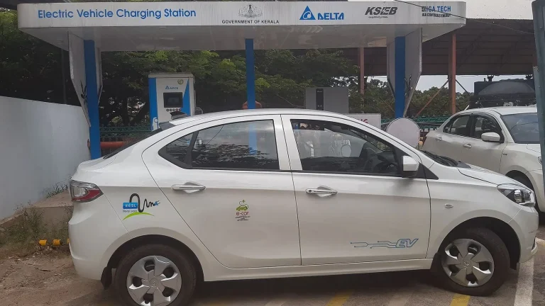 Voiture électrique réelle photographiée près d’une borne de recharge pour « Checklist Indispensable pour l’Achat d’une Hybride Rechargeable d’Occasion »