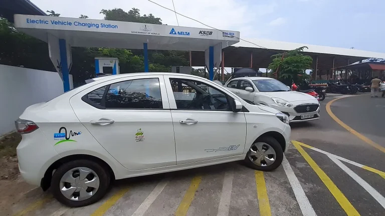Voiture électrique réelle photographiée près d’une borne de recharge pour « Climatisation Voiture d’Occasion: Entretien, Recharge et Réparation des Fuites »